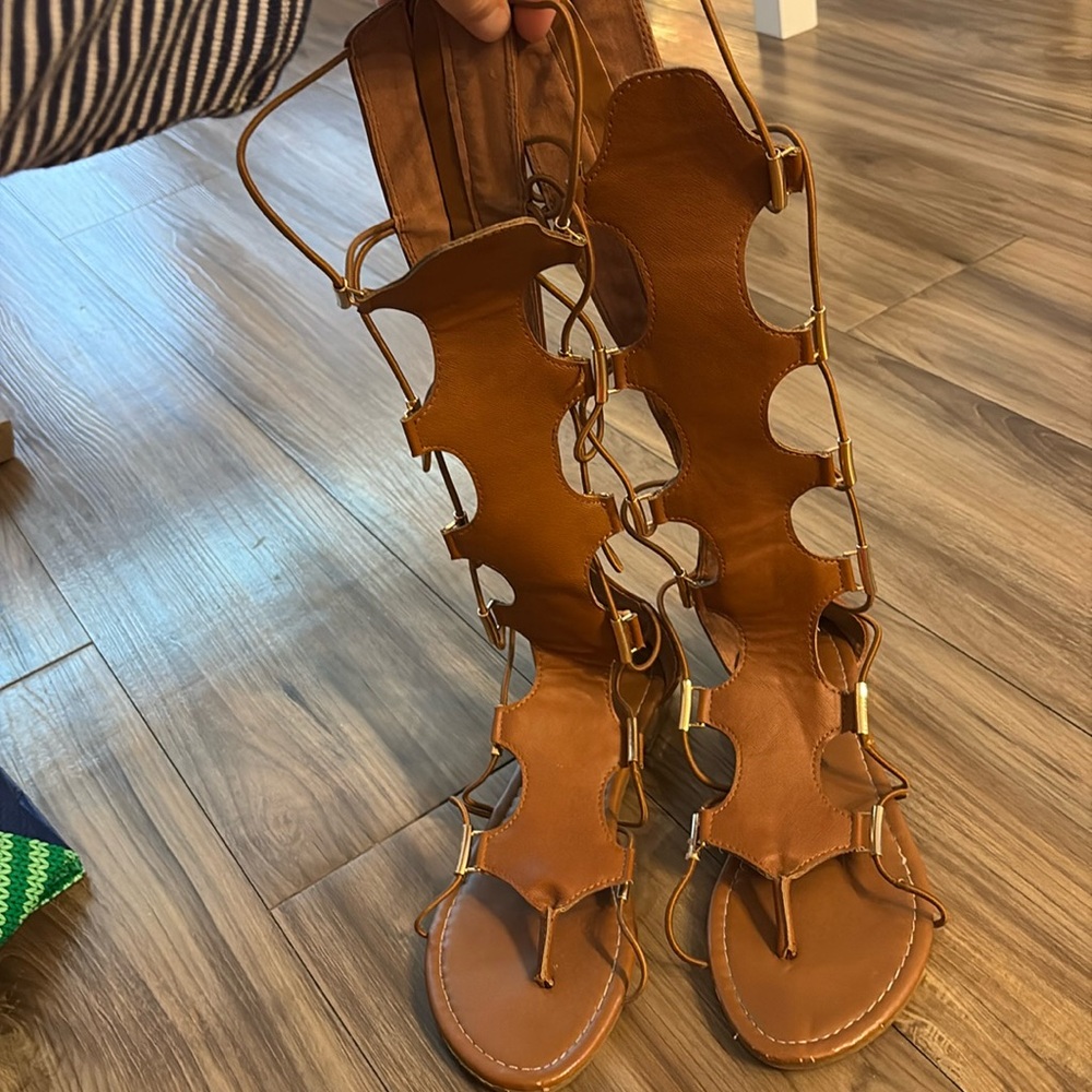 Mid calf stretch laced sandal with gold detail and zipper back closure
